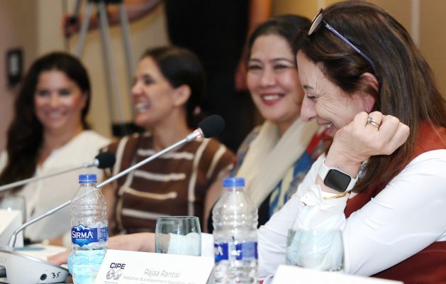 people laughing at a meeting table