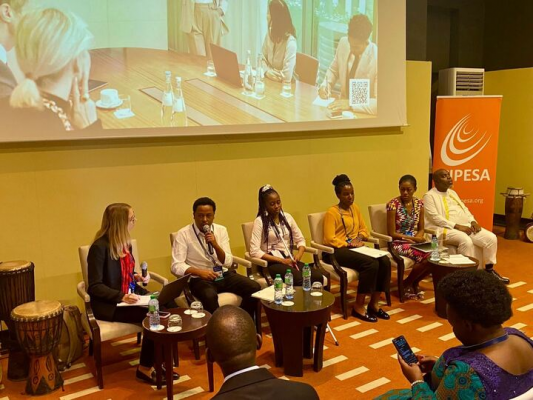 Speakers seated at a panel during the September 26 FIFAfrica session titled “Strengthening Information and Communication Technology (ICT) Accessibility for Persons with Disabilities in Africa.” The panelists are engaged in discussion, with microphones and event branding visible in the background.