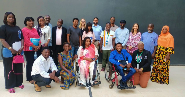 A group of workshop participants poses for a photo at FIFAfrica in Senegal on September 25, 2024. The individuals are standing together outdoors, smiling at the camera, with a lively and collaborative atmosphere.